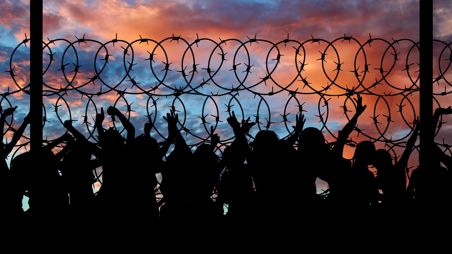 Crowded prisoners by fence