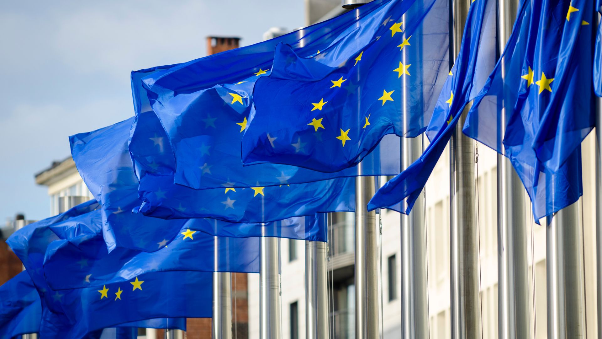 EU flags flying in front of the Commission Berlaymont building
