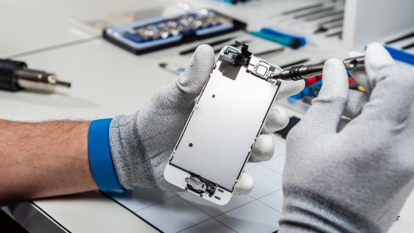 Technician repairing a smartphone