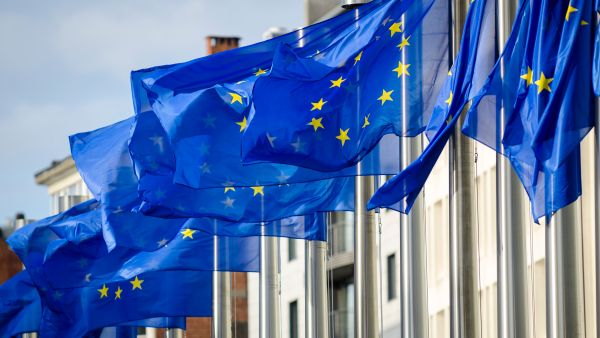 EU flags flying in front of the Commission Berlaymont building