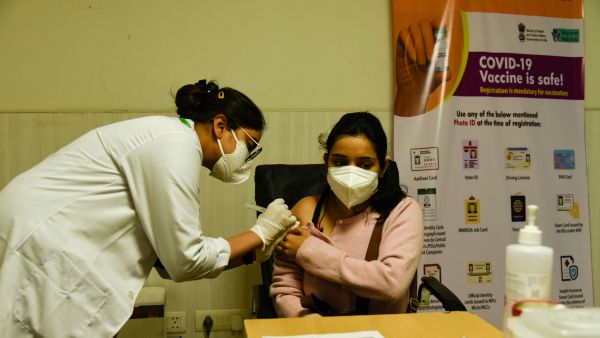 Woman receiving a Covid-19 vaccination in New Delhi, India
