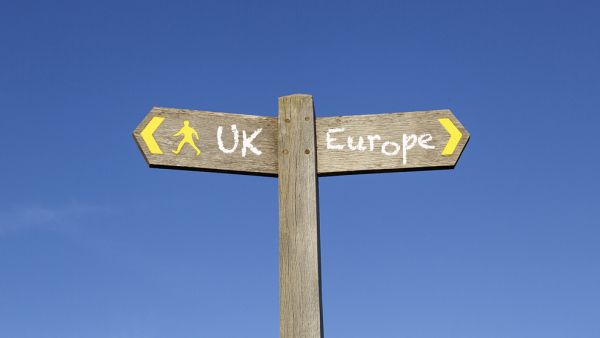 Signposts point in opposite directions to UK and Europe