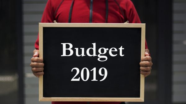 Person holding blackboard saying Budget 2019