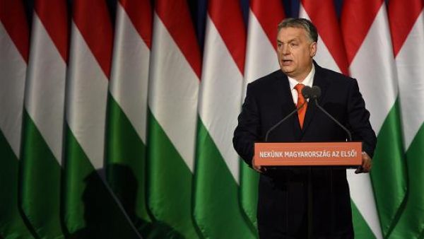 Viktor Orban in front of lots of Hungarian flags