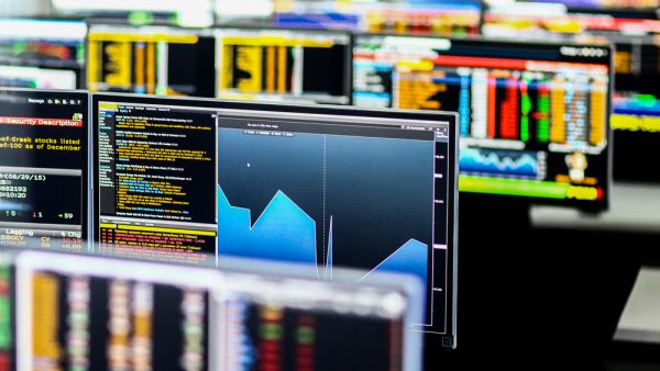 screens showing stock market graphs