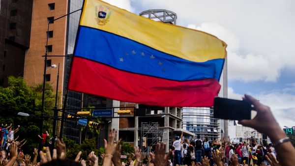 Venezuela flag and people protesting